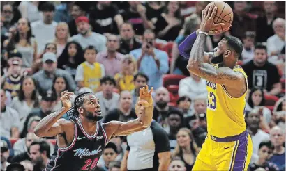  ?? DAVID SANTIAGO MIAMI HERALD ?? LeBron James puts up a shot over Miama Heat defender Justise Winslow on Sunday in Miami.