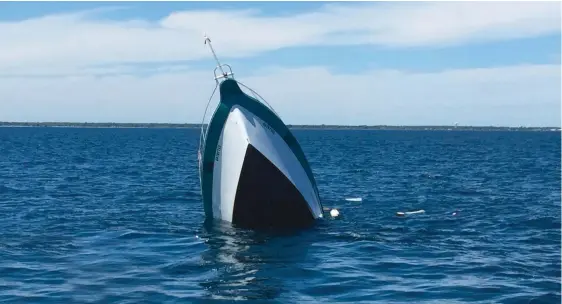  ??  ?? Top: The crew floated off in a life raft and watched as their boat succumbed to the sea. Within 30 minutes, it was on its way to the bottom.