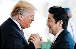  ?? MARIO TAMA/GETTY ?? President Donald Trump greets Japanese Prime Minister Shinzo Abe as he arrives Friday at the White House.