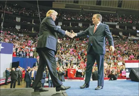  ?? Evan Vucci Associated Press ?? SEN. TED CRUZ of Texas greets President Trump at a Houston campaign rally. Cruz is in a tough reelection fight with Democratic Rep. Beto O’Rourke. Polls show Cruz leading the race, but O’Rourke has raised more campaign money than Cruz, worrying Republican­s.