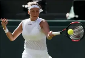  ?? KIRSTY WIGGLESWOR­TH — THE ASSOCIATED PRESS ?? Petra Kvitova returns to Johanna Larsson during their match on the opening day at the Wimbledon in London Monday.