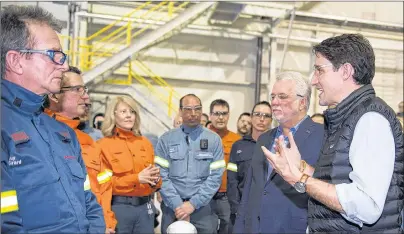  ?? CP PHOTO ?? Quebec Premier Philippe Couillard, left, looks on as Prime Minister Justin Trudeau speaks to workers and reporters at a news conference during a visit of the Rio Tinto AP60 aluminum plant Monday in Saguenay Que.