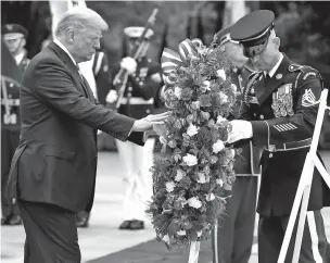  ?? EVAN VUCCI/ASSOCIATED PRESS ?? President Donald Trump lays a wreath at the Tomb of the Unknown Soldier at Arlington National Cemetery on Memorial Day Monday.
