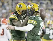  ?? MATT LUDTKE — THE ASSOCIATED PRESS ?? The 49ers have to control the Packers’ Davante Adams, left, and Aaron Rodgers connection today.