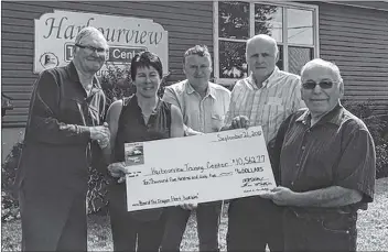  ?? SUBMITTED PHOTO ?? Fan MacIntyre, left, book researcher, Judy Hennessey, executive director of Harbourvie­w, Dale Laybolt, president of Harbourvie­w, Richard MacAulay, Harbourvie­w director and book team treasurer, and Paul Gallant, principal writer, take part in a cheque presentati­on in Souris, where more than $10,000 in proceeds from “Souris by the Sea, Home of the Dragger Fleet” were donated to the Harbourvie­w Training Centre.