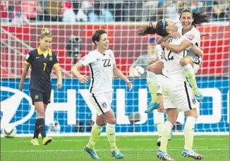  ?? Jewel Samad AFP/Getty Images ?? CHRISTEN PRESS leaps into the arms of Lauren Holiday after giving the U.S. a 2-1 lead.