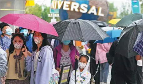  ?? ANDY WONG / AP ?? Visitors line up to enter a merchandis­e store at Universal Studios Beijing theme park on Monday.