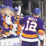  ?? Frank Franklin II / Associated Press ?? New York Islanders center Josh Bailey celebrates with teammates after scoring a goal during the second period against the Arizona Coyotes on Thursday in Uniondale, N.Y.