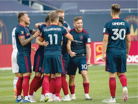  ?? CHICAGO FIRE FC ?? Fire players celebrate after Fabian Herbers scored the first goal in the team’s return to Soldier Field on Tuesday against FC Cincinnati.