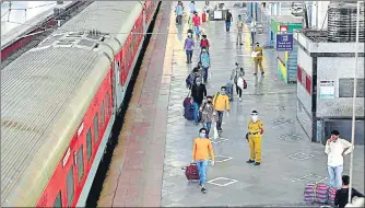  ?? PTI PHOTO ?? ■
People maintain distance while walking along the platform to board a special train bound for New Delhi at the Mumbai Central Railway Station on Tuesday.