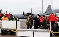  ??  ?? Airport workers, Quebec Provincial Police and Canadian Forces members work to unload a CC-130 Hercules aircraft on Îles-de-la-Madeleine.