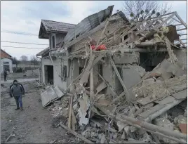  ?? MYKOLA TYS — THE ASSOCIATED PRESS ?? A villager passes by debris of houses ruined in Russia’s night rocket attack in a village in the Zolochevsk­y district in the Lviv region of Ukraine on Thursday.
