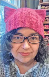  ?? ASSOCIATED PRESS ?? Angie Paulson, who works at a yarn shop in St. Paul, Minn., displays one of the hats she made for marchers to wear during the Women’s March on Washington Saturday.