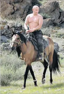  ?? Alexsey Druginyn AFP / Getty Images ?? THEN-RUSSIAN PRIME MINISTER Vladimir Putin rides a horse during his vacation in southern Siberia, Russia, in 2009.