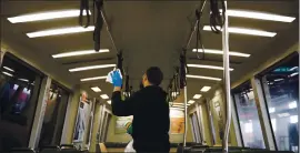  ?? DAI SUGANO — STAFF ARCHIVES ?? A BART utility worker uses disinfecti­ng wipes to sanitize a BART car in March at the Warm Springs/South Fremont station. Officials are also improving car air filters.