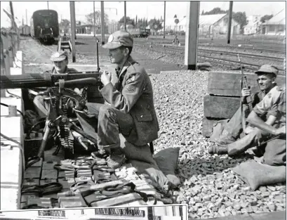  ??  ?? battle: Irish forces on guard duty in Elizabethv­ille, above, and, left, the men pose for photos after the fiveday battle in the Belgian Congo