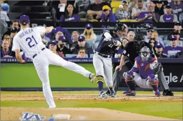  ?? Mark J. Terrill ?? The Associated Press Milwaukee’s Travis Shaw triples off Los Angeles Dodgers starter Walker Buehler on Monday in Game 3 of the National League Championsh­ip Series in Los Angeles.