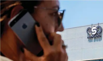  ??  ?? A woman uses her iPhone in front of the building housing the NSO Group’s offices in Herzliya, near Tel Aviv. Photograph: Jack Guez/AFP via Getty Images