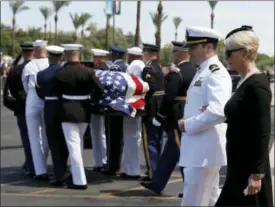  ?? JAE C. HONG — THE ASSOCIATED PRESS ?? Cindy McCain walks with her son Jack as the honor guard carries the casket after a memorial service for Sen. John McCain, R-Ariz. at the North Phoenix Baptist Church on Thursday in Phoenix.