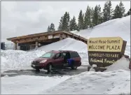  ??  ?? In this March 28 photo taken at the summit of the Mount Rose Highway between Reno, Nev., and Lake Tahoe shows snow piled to the roof of the restrooms at a U.S. Forest Service rest area.