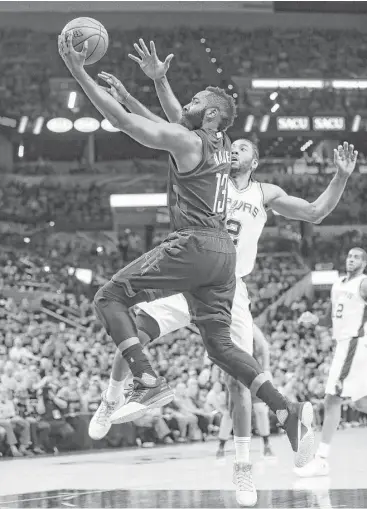  ?? Karen Warren / Houston Chronicle ?? James Harden soars past Kawhi Leonard as the Rockets render the Spurs defenseles­s Monday night.