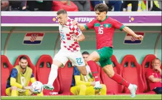  ?? (AP) ?? Croatia’s Josip Juranovic (22) and Morocco’s Abde Ezzalzouli (16) chase after the ball during the World Cup group F soccer match between Morocco and Croatia, at the Al Bayt Stadium in Al Khor, Qatar.