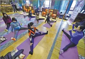  ?? ZHOU MI / XINHUA ?? Mothers-to-be practice yoga at a training institute in Nanchang, Jiangxi province, in January.