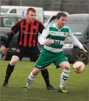  ??  ?? Stephen Kinsella of Gorey Rangers closes in on Darren Dunne of Sheriff Y.C.