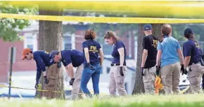  ??  ?? Members of an FBI Evidence Response Team search the grounds at Eugene Simpson Stadium Park in Alexandria, Va., where a shooter opened fire on congressme­n playing baseball.