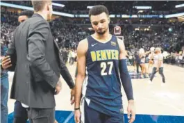  ?? Joe Amon, The Denver Post ?? Nuggets guard Jamal Murray walks off the court after losing at Minnesota on Wednesday. The loss ended Denver’s season.