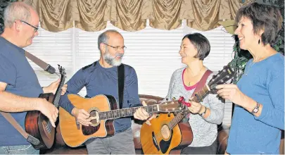  ?? DESIREE ANSTEY/JOURNAL PIONEER ?? Musicians for the folk choir: Mike Johnston, bass guitar, from left, Gary Arsenault, guitar, Ramona Roberts, guitar, and Marina Trainor, playing harmonica.