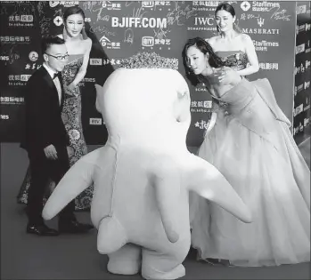  ?? Andy Wong Associated Press ?? LOCALLY produced movies such as “Monster Hunt,” which set a box- off ice record for a domestic release, have generated big returns in China. Above, director Xu Chengyi, left, and actress Bai Baihe in April.