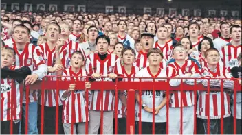  ??  ?? True colours: Sunderland fans at Roker Park pictured by Stuart Roy Clarke in his photograph­ic study of football venues