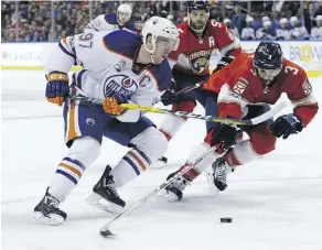  ?? LYNNE SLADKY/THE ASSOCIATED PRESS ?? Connor McDavid and Panthers defenceman Keith Yandle go for the puck Wednesday night in Sunrise, Fla.