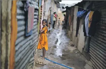  ?? Aijaz Rahi Associated Press ?? JERIFA ISLAM and her family moved to Bengaluru, India, after floods destroyed their home in Assam state. Many residents in the suburban area where they now live were forced to migrate because of climate change.