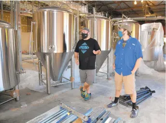  ?? PAULW. GILLESPIE/CAPITAL GAZETTE PHOTOS ?? Pherm Brewing Company owners Billy Abbott, left, and Henry Jager stand in front of the brewing tanks.