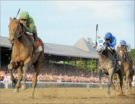  ?? NYRA PHOTO ?? Keen Ice, left, crosses the finish line ahead of Triple Crown winner American Pharoah to win the Travers Stakes at Saratoga Race Course Friday, Aug. 29, 2015.