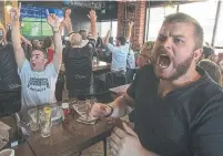  ?? RICK MADONIK TORONTO STAR ?? Austen McMurchy, left, and Gareth Reid, celebrate at a Toronto Wolfpack viewing party at Three Brewers in Liberty Village.