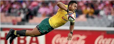  ??  ?? Samu Kerevi launches himself at the tryline for the Wallabies in Yokohama yesterday.