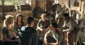  ?? PHOTO BY JOE ALBLAS — TWENTIETH CENTURY FOX ?? In “Maze Runner: The Death Cure” the group decides on their next move. Shown from left are, Sonya (Katherine McNamara), Harriet (Nathalie Emmanuel), Aris (Jacob Lofland, back to camera), Newt (Thomas Brodie-Sangster), Thomas (Dylan O’Brien), Brenda...