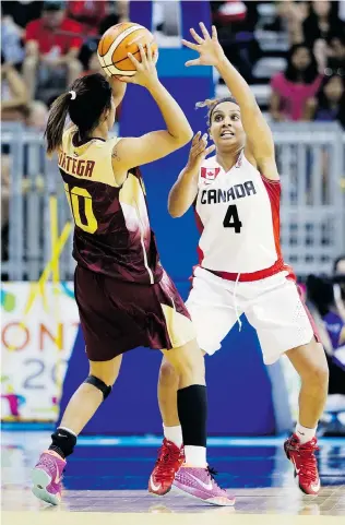  ?? MARK HUMPHREY/The Associated Press ?? Windsor’s Miah Marie Langloi, right, defends against Venezuela’s Luisana Ortega Ochoa in the first
half of Canada’s preliminar­y round basketball game at the Pan Am Games Thursday in Toronto.