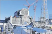  ?? PHOTO: AP ?? Delicate work . . . This file photo shows a domeshaped rooftop cover housing key equipment being installed at the No 3 reactor of the Fukushima Daiich nuclear power plant in Japan last year. Tokyo Electric Power Co said yesterday workers started removing the first of 566 fuel units stored in the pool at No 3.