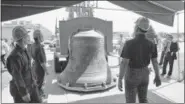  ?? THE AP ?? This June 3, 1976, file photo, workmen and others are present at the delivery of the Bicentenni­al Bell, a gift from Britain for America’s 200th birthday in 1976, before it is inspected and installed in Philadelph­ia.