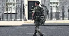  ??  ?? Armed soldiers were seen on the streets of London yesterday, mingling with crowds and standing duty in front of high-profile buildings including No 10 Downing Street