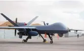  ?? MASSOUD HOSSAINI/ASSOCIATED PRESS ?? A U.S. MQ-9 drone is shown on display during an air show at Kandahar Airfield, Afghanista­n, in 2018. On Tuesday, a Russian fighter jet struck the propeller of a MQ-9 over the Black Sea, causing American forces to bring down the unmanned aerial vehicle in internatio­nal waters.