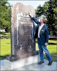  ?? Arkansas Democrat-Gazette/JEFF MITCHELL ?? Scott Stewart, a senior pastor at the Agape Church in west Little Rock, checks out the Ten Commandmen­ts monument Tuesday on the state Capitol grounds. The design was taken from the tablet in Cecil B. DeMille’s 1956 film of the same name.