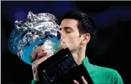  ?? NEW YORK TIMES) (ASANKA BRENDON RATNAYAKE/THE ?? Novak Djokovic of Serbia kisses the trophy after defeating Austria’s Dominic Thiem to win the Australian Open, at Rod Laver Arena in Melbourne, Australia, on 2 Feb 2020.