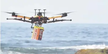  ??  ?? A file photo of a drone skimming across the ocean with a safety flotation device attached. — AFP photo