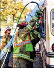  ?? SUBMITTED PHOTO ?? School bus rescues can even require volunteers to be trained on how to access the bus from the roof.