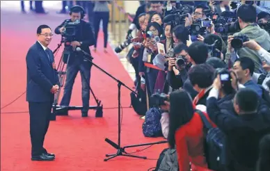  ?? WANG ZHUANGFEI / CHINA DAILY ?? Luo Shugang, minister of culture, speaks with reporters about protecting historical artifacts on the sidelines of the annual session of the 13th National People’s Congress in Beijing on Tuesday.